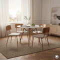 The Astra 100cm round dining table with matte white top and solid beech wood legs styled in a Scandi-inspired dining area.