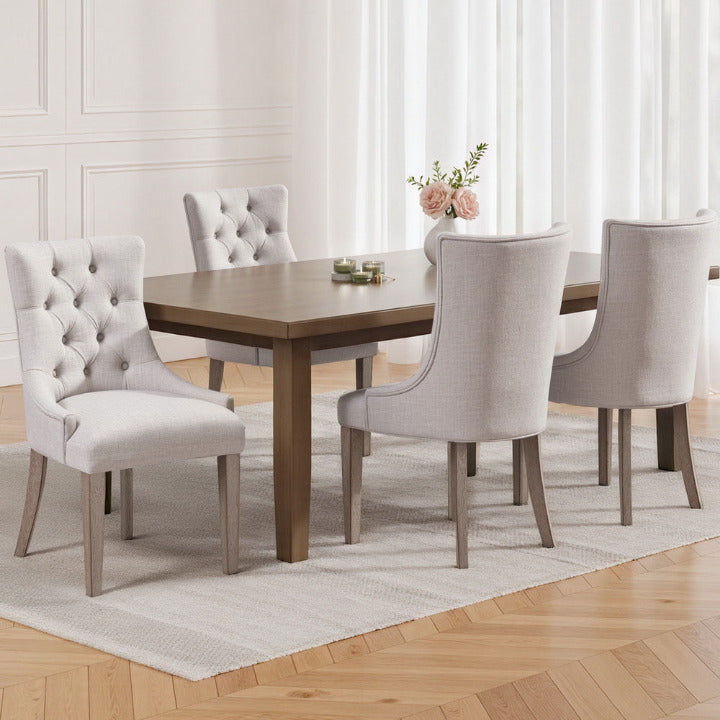 Set of 4 Brittany French Provincial dining chairs in cream beige linen with button-tufted backrests in a Hamptons style dining room.