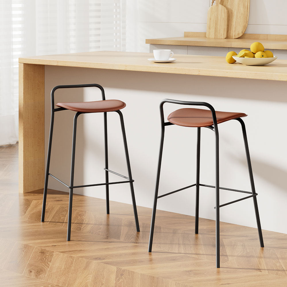 Set of 2 The Bronte Loft brown PU leather bar stools with black metal legs at a modern wooden kitchen island in an Australian home.