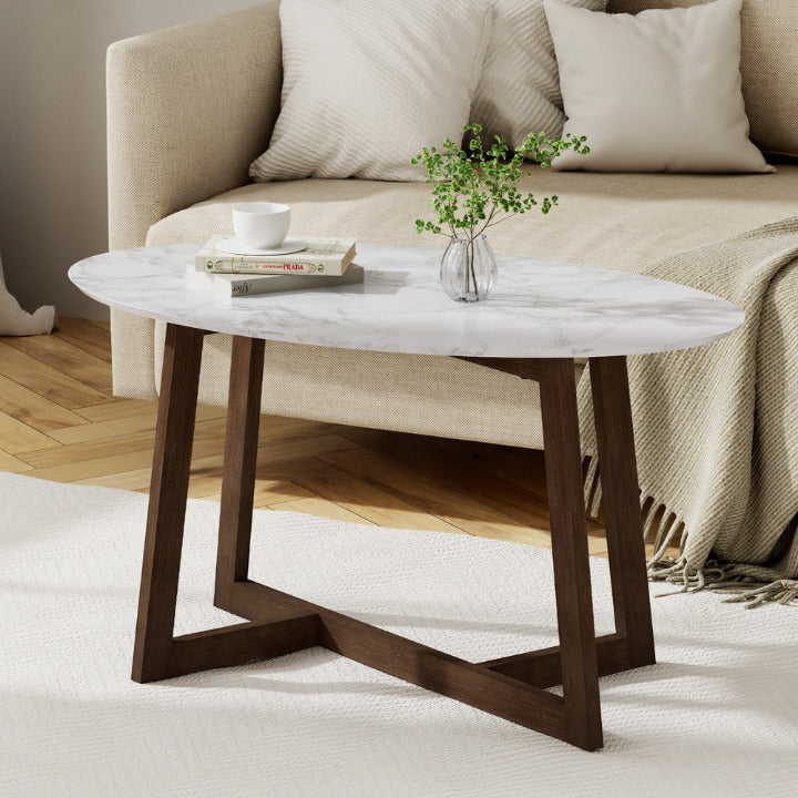 The Clara 80cm oval coffee table with white marble top and walnut rubberwood legs in a modern Melbourne living room.