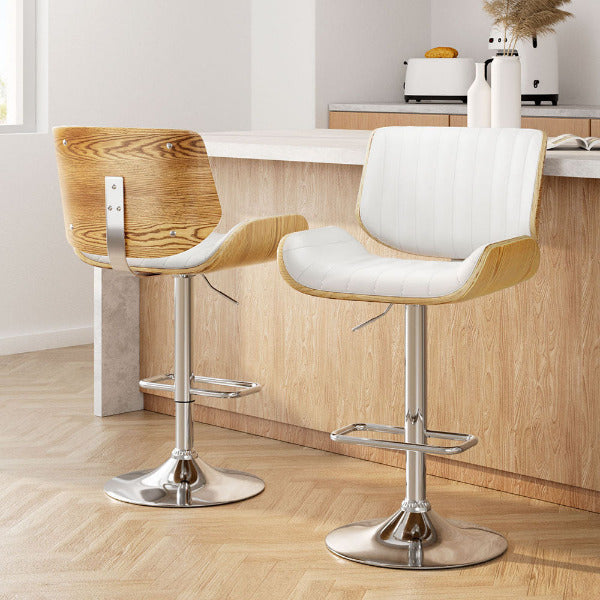 Set of 2 Galina adjustable bar stools with oak bentwood shells and white leatherette seats in a Scandi kitchen.
