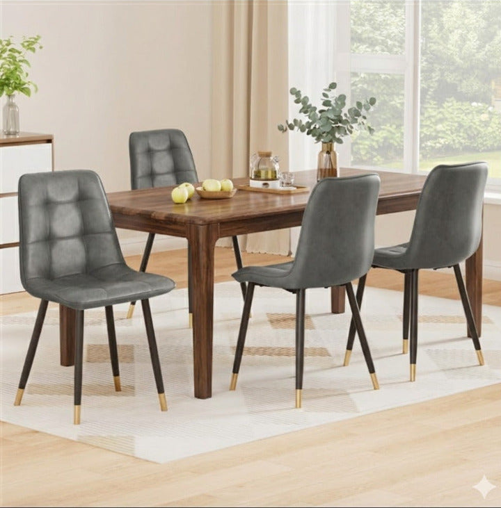 Set of 4 Griffin grid-tufted dining chairs in slate grey PU leather with matte black steel legs in a contemporary dining room.