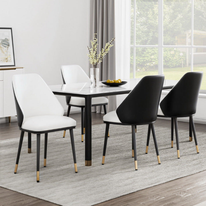 Set of 4 Monroe dual-tone dining chairs with ivory interior and black exterior shell in a luxury modern dining room.