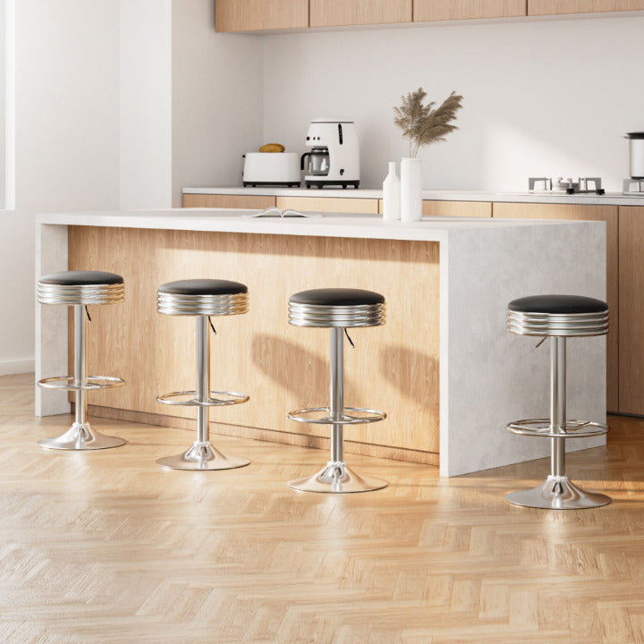 Set of 4 Retro Rocket gas lift stools with polished chrome bases and black leatherette seats at a modern kitchen island.