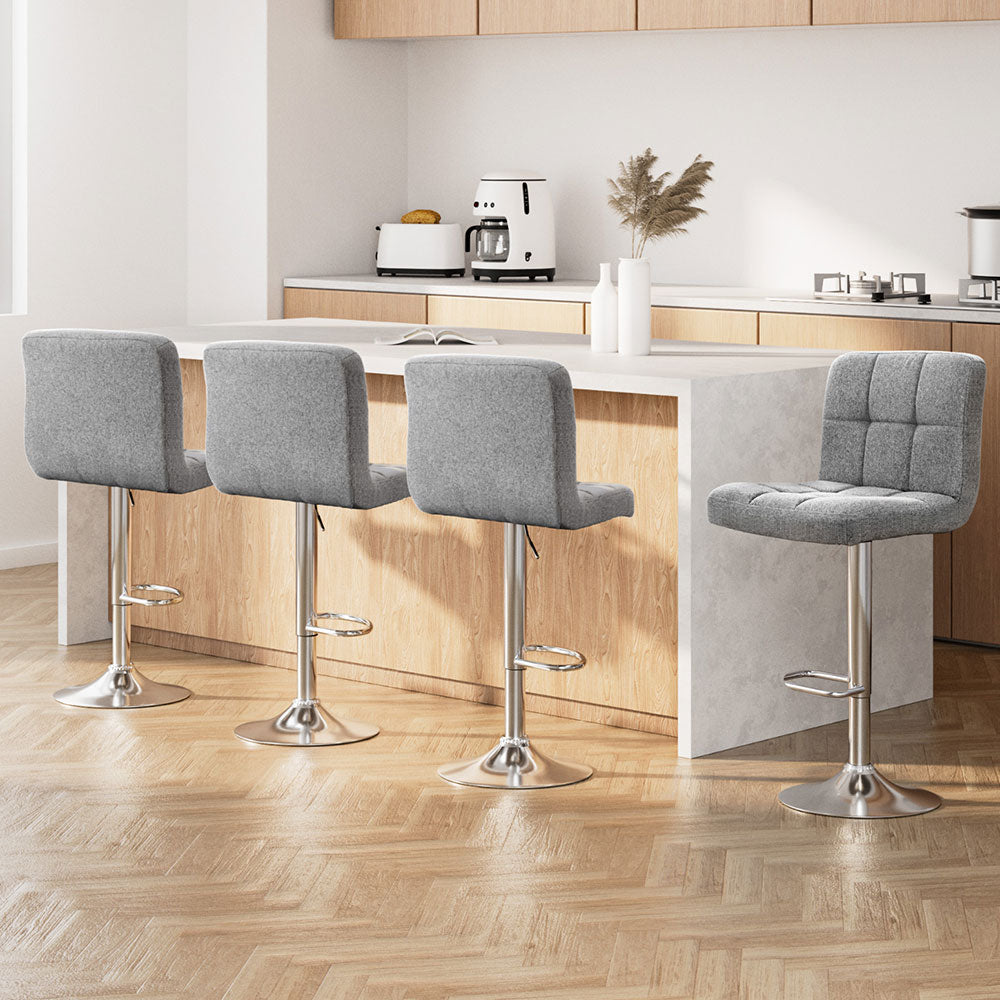 Set of 4 Luca soft grey tufted fabric bar stools with chrome bases styled at a modern kitchen breakfast bar in Melbourne.