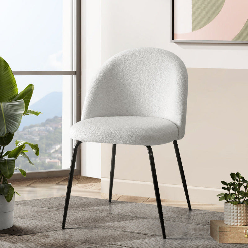 Set of 2 Tofa Curve dining chairs in white Sherpa Bouclé fabric with black legs in a modern minimalist dining room.