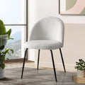 Set of 2 Tofa Curve dining chairs in white Sherpa Bouclé fabric with black legs in a modern minimalist dining room.
