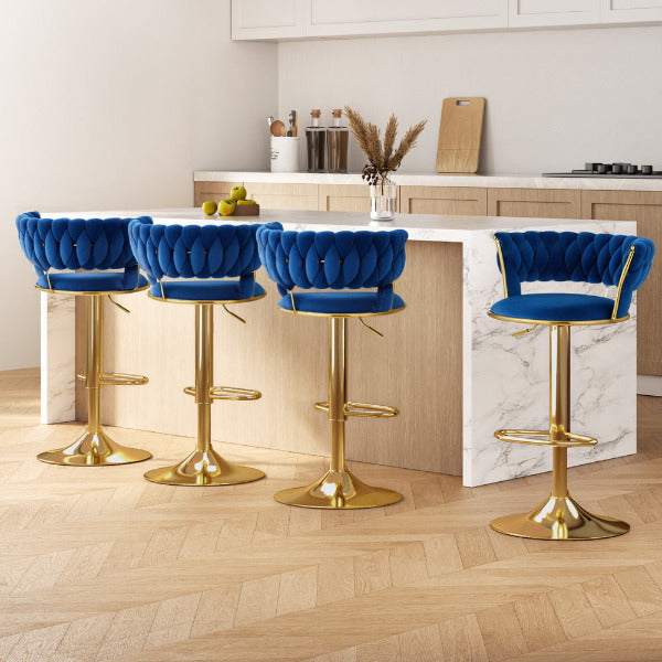 Set of 4 Vivien luxury bar stools with navy velvet woven backrests and polished gold pedestal bases at a modern kitchen island.